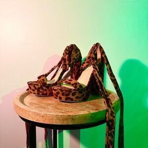Leopard print platform heels with tie-up detail.